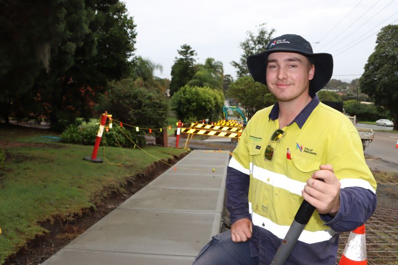 City of Newcastle civil construction trainee Mitch Curry at work on the construction of a 320-metre long section of footpath on the northern side of Newcastle Road in Jesmond.
