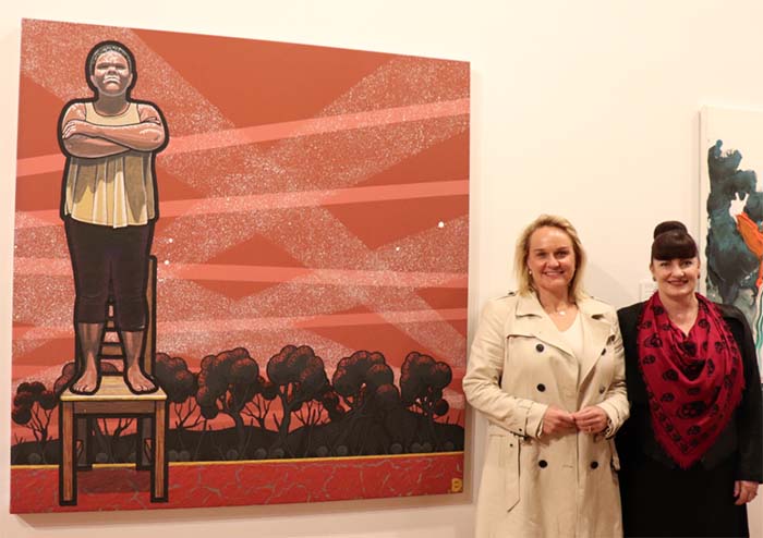 Newcastle Lord Mayor Nuatali Nelmes and Newcastle Art Gallery Director Lauretta Morton with the winning Kilgour Prize artwork by Sydney-based artist Blak Douglas.