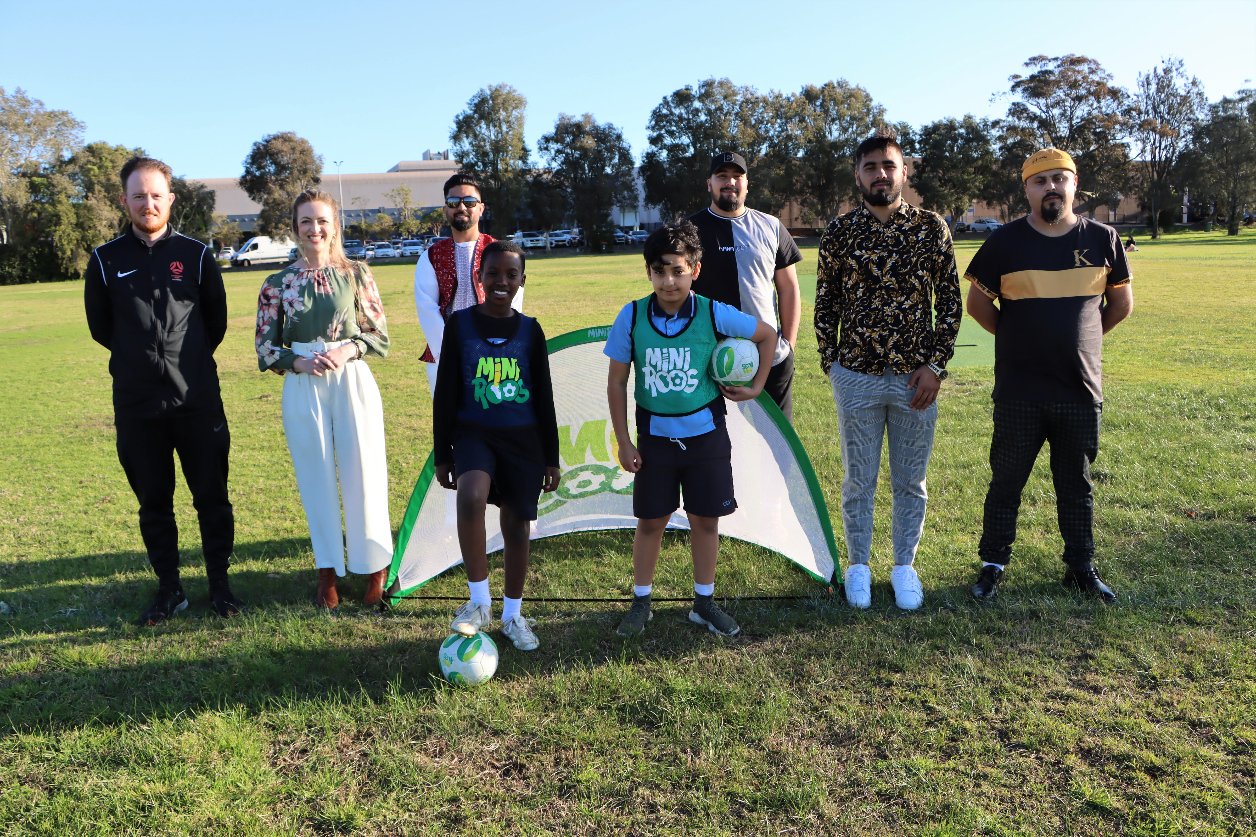 Budding footballers Mohamed Dia, 11 and Daniel Zanganeh, 9 (front) with Joseph Wright from Northern NSW Football, Newcastle Councillor Dr Elizabeth Adamczyk, and representatives from the Afghan Association of Hunter Mohammad Nasir, Sajad Ahmad, Jawid Ahmad and Fardin Rahmani.