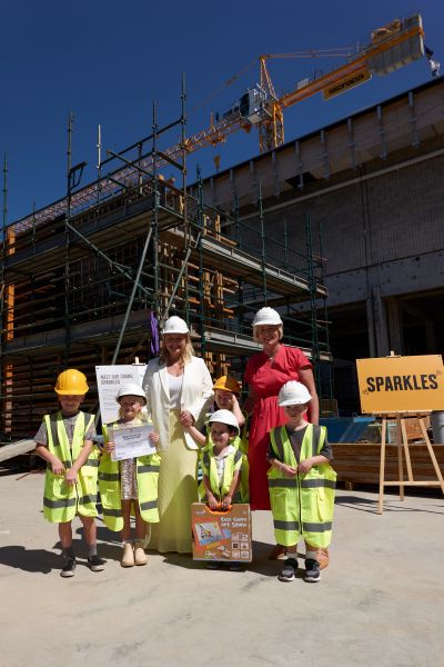 Newcastle Lord Mayor Nuatali Nelmes and NSW Minister for the Hunter Yasmin Catley with the winner and runners-up in the Name the Crane competition at the Newcastle Art Gallery construction site.