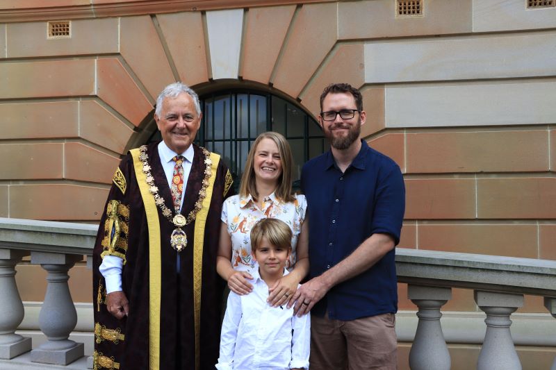 Lord Mayor Ross Kerridge outside Newcastle City Hall with new citizen Laura Stapp, her husband Kyle Stapp and their son Oscar Stapp.