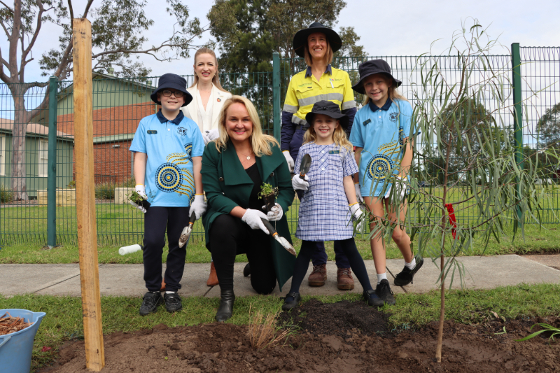 Cr Elizabeth Adamczyk, Lord Mayor Nuatali Nelmes and City of Newcastle Environmental Education Officer Elise Budden help students from Beresfield Public School plant trees, grasses and small flowering plants.